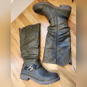 Dark green boots with fuzzy lining and buckle detail